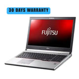 Fujitsu laptop with a 30-day warranty on a white background