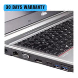 Laptop with ports and keyboard, featuring a 30-day warranty label.