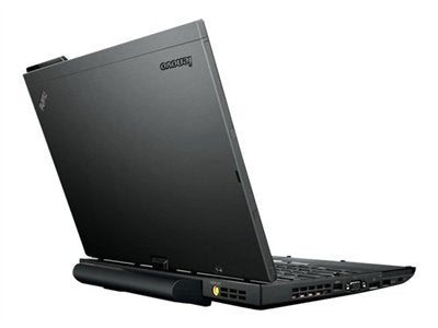 Rear-left angled view of an open Lenovo ThinkPad X230, showing the black matte lid, extended battery, and side ventilation ports.- Rentopc