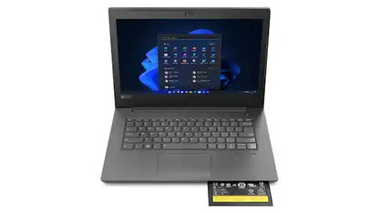 A dark gray open laptop on a white background, with its screen turned on and a small battery or accessory placed in front of the keyboard.